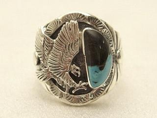 Genuine Sunnyside Turquoise set in Sterling Silver Ring. Beautiful Eagle Design. The matrix on this rare stone is outstanding. The Sunnyside mine is located in northern Nevada near the town of Tuscarora in the Tuscarora mountain range. The mine is no longer in operation as it has become part of a gold mining operation and a privately owned ranch. The Sunnyside mine was mined mostly in the 70's. You won't find much of this great turquoise around anymore except for old stashes. Created by Navajo Artist Freddy Charley. Signed. 
