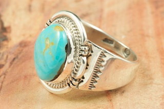 Genuine Manassa Turquoise set in Sterling Silver Ring. This Turquoise is also referred to as King�s Manassa Turquoise. The Manassa Turquoise mine is located in Manassa, Conejos County, Colorado. Created by Navajo Artist John Nelson. Signed.