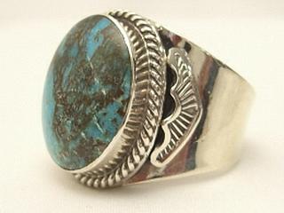 Genuine Sunnyside Turquoise set in Sterling Silver Ring. The matrix on this rare stone is outstanding. The Sunnyside mine is located in northern Nevada near the town of Tuscarora in the Tuscarora mountain range. The mine is no longer in operation as it has become part of a gold mining operation and a privately owned ranch. The Sunnyside mine was mined mostly in the 70's. You won't find much of this great turquoise around anymore except for old stashes. Created by Navajo Artist Larson Lee. Signed.