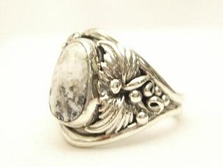White Buffalo Turquoise set in Sterling Silver Ring. This Beautiful Stone is formed from the minerals Calcite and Iron. It is mined near Tonopah Nevada. Created by Navajo Artist Bobby Piaso. Signed.
