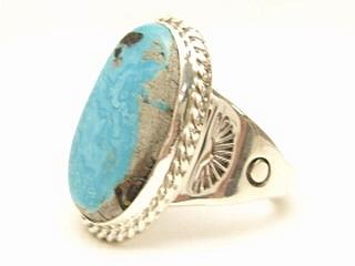 Genuine Sunnyside Turquoise set in Sterling Silver Ring. The matrix on this rare stone is outstanding. The Sunnyside mine is located in northern Nevada near the town of Tuscarora in the Tuscarora mountain range. The mine is no longer in operation as it has become part of a gold mining operation and a privately owned ranch. The Sunnyside mine was mined mostly in the 70's. You won't find much of this great turquoise around anymore except for old stashes. Created by Navajo Artist Phillip Sanchez. Signed.