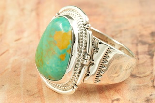 Genuine Manassa Turquoise set in Sterling Silver Ring. This Turquoise is also referred to as King�s Manassa Turquoise. The Manassa Turquoise mine is located in Manassa, Conejos County, Colorado. Created by Navajo Artist John Nelson. Signed by the artist.