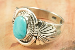 Genuine Castle Dome Turquoise set in Sterling Silver Ring. Created by Navajo Artist Thomas Chischilly. Signed by the artist. The Castle Dome Turquoise Mine is located about 30 miles from the Sleeping Beauty Mine, near Globe, Arizona. The Castle Dome Mine has not been in operation since the early 1970s.