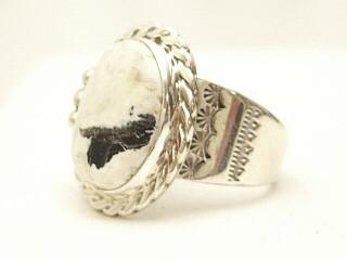 White Buffalo Turquoise set in Sterling Silver Ring. This Beautiful Stone is formed from the minerals Calcite and Iron. It is mined near Tonopah Nevada. Created by Navajo Artist Tony Garcia. Signed. 
