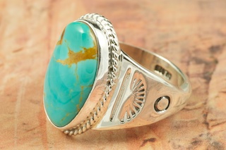 Genuine Manassa Turquoise set in Sterling Silver Ring. This Turquoise is also referred to as King�s Manassa Turquoise. The Manassa Turquoise mine is located in Manassa, Conejos County, Colorado. Created by Navajo Artist Phillip Sanchez. Signed by the artist.