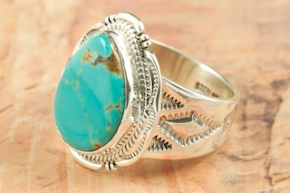 Genuine Manassa Turquoise set in Sterling Silver Ring. This Turquoise is also referred to as King�s Manassa Turquoise. The Manassa Turquoise mine is located in Manassa, Conejos County, Colorado. Created by Navajo Artist John Nelson. Signed by the artist.
