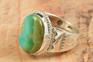 Genuine Manassa Turquoise set in Sterling Silver Ring. This Turquoise is also referred to as King�s Manassa Turquoise. The Manassa Turquoise mine is located in Manassa, Conejos County, Colorado. Created by Navajo Artist Phillip Sanchez. Signed by the artist.