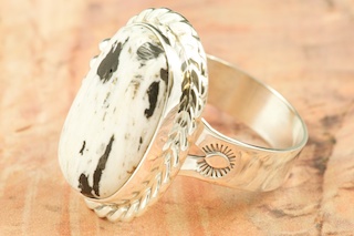 White Buffalo Turquoise set in Sterling Silver Ring. Beautiful Stone is formed from the minerals Calcite and Iron. It is mined near Tonopah Nevada. Created by Navajo Artist Tony Garcia. Signed by the artist.