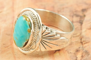 Genuine Manassa Turquoise set in Sterling Silver Ring. This Turquoise is also referred to as King�s Manassa Turquoise. The Manassa Turquoise mine is located in Manassa, Conejos County, Colorado. Created by Navajo Artist John Nelson. Signed by the artist.