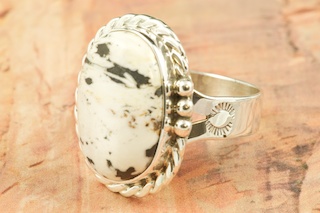 White Buffalo Turquoise set in Sterling Silver Ring. This Beautiful Stone is formed from the minerals Calcite and Iron. It is mined near Tonopah Nevada. Created by Navajo Artist Tony Garcia. Signed by the artist.