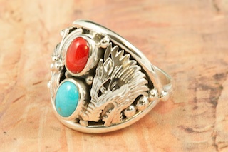 Genuine Sleeping Beauty Turquoise and Coral set in Sterling Silver Ring. Beautiful Wolf and Leaf Design in Sterling Silver. The Sleeping Beauty Turquoise mine is located in Gila County, Arizona. Created by Navajo Artist Freddy Charley. Signed by the artist.