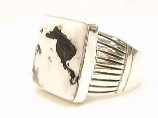 White Buffalo Turquoise set in Sterling Silver Ring. This Beautiful Stone is formed from the minerals Calcite and Iron. It is mined near Tonopah Nevada. Created by Navajo Artist Thomas Chischilly. Signed. 
