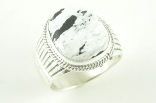 White Buffalo Turquoise set in Sterling Silver Ring. This Beautiful Stone is formed from the minerals Calcite and Iron. It is mined near Tonopah Nevada. Created by Navajo Artist Phillip Sanchez. Signed. 
