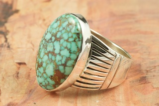 Genuine High Grade Kingman Turquoise set in Sterling Silver Ring. Beautiful Spider Web Matrix. The Kingman Turquoise Mine is located in Mohave County, Arizona. Created by Navajo Artist Phillip Sanchez. Signed by the artist.