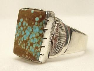 Genuine Number 8 Turquoise set in Sterling Silver Ring. The Number 8 mine is located in Eureka County Nevada. Since 1976 there has been no Number 8 Turquoise mined. There is however, an existing stock pile that Mr. Dowell Ward, the last owner of the Number 8 mine, had stocked away for later sorting. The Turquoise is a collector's item--because once the reserve is gone there will be no more material released onto the market. The Gold Mining Company owns the claim to the Number 8 mine and it has been swallowed up by the gold mining operations. This is some of the last Number 8 Turquoise to be had and will be a great addition to your collection. Created by Navajo Artist Will Vandever. Signed.