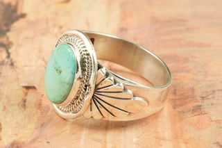 Genuine Manassa Turquoise set in Sterling Silver Ring. This Turquoise is also referred to as King�s Manassa Turquoise. The Manassa Turquoise mine is located in Manassa, Conejos County, Colorado. Created by Navajo Artist John Nelson. Signed by the artist.
