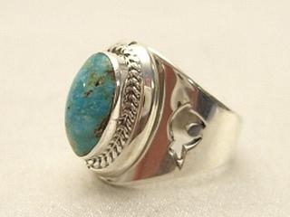 Genuine Sunnyside Turquoise set in Sterling Silver Ring. The matrix on this rare stone is outstanding. The Sunnyside mine is located in northern Nevada near the town of Tuscarora in the Tuscarora mountain range. The mine is no longer in operation as it has become part of a gold mining operation and a privately owned ranch. The Sunnyside mine was mined mostly in the 70's. You won't find much of this great turquoise around anymore except for old stashes. Created by Navajo Artist Herbert Pino. Signed.