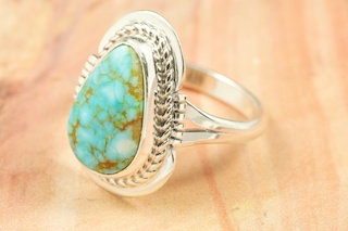 Genuine Number 8 Turquoise set in Sterling Silver Ring. The Number 8 mine is located in Eureka County Nevada. Since 1976 there has been no Number 8 Turquoise mined. There is however, an existing stock pile that Mr. Dowell Ward, the last owner of the Number 8 mine, had stocked away for later sorting. The Turquoise is a collector's item--because once the reserve is gone there will be no more material released onto the market. The Gold Mining Company owns the claim to the Number 8 mine and it has been swallowed up by the gold mining operations. This is some of the last Number 8 Turquoise to be had and will be a great addition to your collection. Created by Navajo Artist Margaret Platero. Signed by the artist.