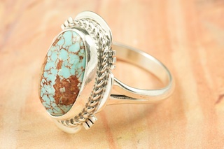 Genuine Number 8 Turquoise set in Sterling Silver Ring. The Number 8 mine is located in Eureka County Nevada. Since 1976 there has been no Number 8 Turquoise mined. There is however, an existing stock pile that Mr. Dowell Ward, the last owner of the Number 8 mine, had stocked away for later sorting. The Turquoise is a collector's item--because once the reserve is gone there will be no more material released onto the market. The Gold Mining Company owns the claim to the Number 8 mine and it has been swallowed up by the gold mining operations. This is some of the last Number 8 Turquoise to be had and will be a great addition to your collection. Created by Navajo Artist Margaret Platero. Signed by the artist.