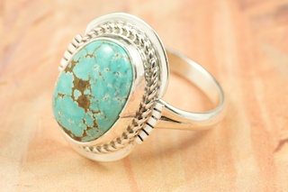 Genuine Number 8 Turquoise set in Sterling Silver Ring. The Number 8 mine is located in Eureka County Nevada. Since 1976 there has been no Number 8 Turquoise mined. There is however, an existing stock pile that Mr. Dowell Ward, the last owner of the Number 8 mine, had stocked away for later sorting. The Turquoise is a collector's item--because once the reserve is gone there will be no more material released onto the market. The Gold Mining Company owns the claim to the Number 8 mine and it has been swallowed up by the gold mining operations. This is some of the last Number 8 Turquoise to be had and will be a great addition to your collection. Created by Navajo Artist Margaret Platero. Signed by the artist.
