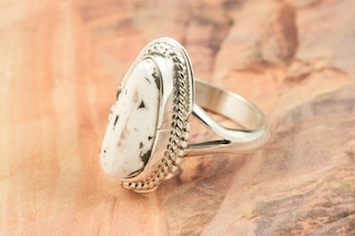 White Buffalo Turquoise set in Sterling Silver Ring. This Beautiful Stone is formed from the minerals Calcite and Iron. It is mined near Tonopah Nevada. Created by Navajo Artist Larson Lee. Signed by the artist.