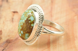 Genuine Number 8 Turquoise set in Sterling Silver Ring. The Number 8 mine is located in Eureka County Nevada. Since 1976 there has been no Number 8 Turquoise mined. There is however, an existing stock pile that Mr. Dowell Ward, the last owner of the Number 8 mine, had stocked away for later sorting. The Turquoise is a collector's item--because once the reserve is gone there will be no more material released onto the market. The Gold Mining Company owns the claim to the Number 8 mine and it has been swallowed up by the gold mining operations. This is some of the last Number 8 Turquoise to be had and will be a great addition to your collection. Created by Navajo Artist Margaret Platero. Signed by the artist.