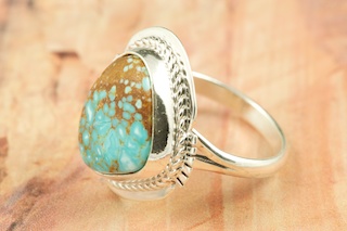 Genuine Number 8 Turquoise set in Sterling Silver Ring. The Number 8 mine is located in Eureka County Nevada. Since 1976 there has been no Number 8 Turquoise mined. There is however, an existing stock pile that Mr. Dowell Ward, the last owner of the Number 8 mine, had stocked away for later sorting. The Turquoise is a collector's item--because once the reserve is gone there will be no more material released onto the market. The Gold Mining Company owns the claim to the Number 8 mine and it has been swallowed up by the gold mining operations. This is some of the last Number 8 Turquoise to be had and will be a great addition to your collection. Created by Navajo Artist Margaret Platero. Signed by the artist.