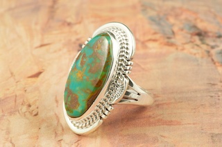 Genuine Royston Turquoise set in Sterling Silver Ring. The Royston Turquoise Mine was originally known as the Royal Blue Mine. It produces Turquoise that has a mixture of blues and greens in the same formation. The Royston Turquoise Mine is located in Nye County, Nevada. Created by Navajo Artist John Nelson. Signed by the artist.