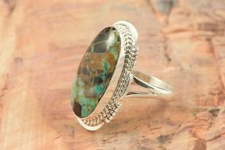 Genuine Sunnyside Turquoise set in Sterling Silver Ring. The matrix on this rare stone is outstanding. The Sunnyside mine is located in northern Nevada near the town of Tuscarora in the Tuscarora mountain range. The mine is no longer in operation as it has become part of a gold mining operation and a privately owned ranch. The Sunnyside mine was mined mostly in the 70's. You won't find much of this great turquoise around anymore except for old stashes. Created by Navajo Artist Margaret Platero. Signed by the artist.