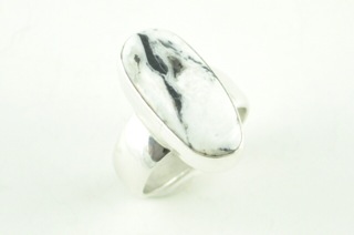 White Buffalo Turquoise set in Sterling Silver Ring. This Beautiful Stone is formed from the minerals Calcite and Iron. It is mined near Tonopah Nevada. Created by Navajo Artist Tony Garcia. Signed. 
