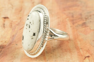 White Buffalo Turquoise set in Sterling Silver Ring. This Beautiful Stone is formed from the minerals Calcite and Iron. It is mined near Tonopah Nevada. Created by Navajo Artist Tony Garcia. Signed. 
