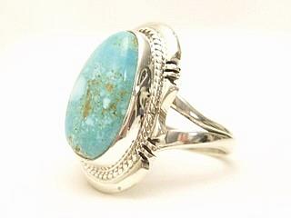 Genuine Number 8 Turquoise set in Sterling Silver Ring. The Number 8 mine is located in Eureka County Nevada. Since 1976 there has been no Number 8 Turquoise mined. There is however, an existing stock pile that Mr. Dowell Ward, the last owner of the Number 8 mine, had stocked away for later sorting. The Turquoise is a collector's item--because once the reserve is gone there will be no more material released onto the market. The Gold Mining Company owns the claim to the Number 8 mine and it has been swallowed up by the gold mining operations. This is some of the last Number 8 Turquoise to be had and will be a great addition to your collection. Created by Navajo Artist John Nelson. Signed. 
