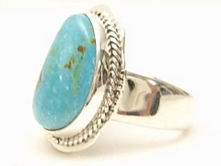 Genuine Number 8 Turquoise set in Sterling Silver Ring. Beautiful Kokopelli and Bear Designs. The Number 8 mine is located in Eureka County Nevada. Since 1976 there has been no Number 8 Turquoise mined. There is however, an existing stock pile that Mr. Dowell Ward, the last owner of the Number 8 mine, had stocked away for later sorting. The Turquoise is a collector's item--because once the reserve is gone there will be no more material released onto the market. The Gold Mining Company owns the claim to the Number 8 mine and it has been swallowed up by the gold mining operations. This is some of the last Number 8 Turquoise to be had and will be a great addition to your collection. Created by Navajo Artist John Nelson. 
