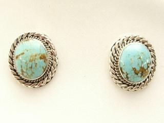 Genuine Number 8 Mine Turquoise Stones set in Sterling Silver Post Earrings. The Number 8 mine is located in Eureka County Nevada. Since 1976 there has been no Number 8 Turquoise mined. There is however, an existing stock pile that Mr. Dowell Ward, the last owner of the Number 8 mine, had stocked away for later sorting. The Turquoise is a collector's item--because once the reserve is gone there will be no more material released onto the market. The Gold Mining Company owns the claim to the Number 8 mine and it has been swallowed up by the gold mining operations. This is some of the last Number 8 Turquoise to be had and will be a great addition to your collection. Created by Navajo Artist Flora Willeto. Signed.