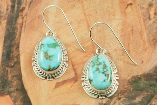 Genuine Crow Springs Turquoise set in Sterling Silver French Wire Earrings. The Crow Springs Mine is located near Tonopah, Nevada. Created by Navajo Artist BJ Piaso. Signed.