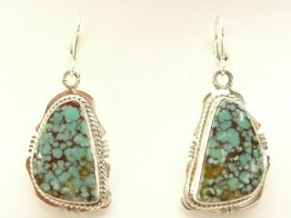 Genuine Emerald Valley Turquoise set in Sterling Silver French Wire Earrings. The Emerald Valley Mine is located in Nevada. Created by Navajo Artist Kathy Yazzie. Signed.