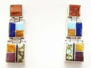 Genuine Turquoise,, Spiny Oyster Shell, Sugilite and Blue Lapis inlaid between ribbons of Sterling Silver. Beautiful Sterling Silver Post Earrings feature precision channel inlay. Designed by Navajo Artist Calvin Begay. Signed.

