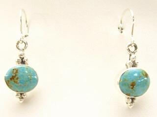 Genuine Number 8 Mine Turquoise Stones set in Sterling Silver French Wire Earrings. The Number 8 mine is located in Eureka County Nevada. Since 1976 there has been no Number 8 Turquoise mined. There is however, an existing stock pile that Mr. Dowell Ward, the last owner of the Number 8 mine, had stocked away for later sorting. The Turquoise is a collector's item--because once the reserve is gone there will be no more material released onto the market. The Gold Mining Company owns the claim to the Number 8 mine and it has been swallowed up by the gold mining operations. This is some of the last Number 8 Turquoise to be had and will be a great addition to your collection. Signed by Navajo Artist Lucy Valencia. Signed LJ.

