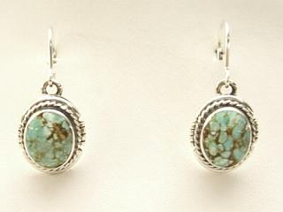 Genuine Number 8 Mine Turquoise Stones set in Sterling Silver French Wire Earrings. The Number 8 mine is located in Eureka County Nevada. Since 1976 there has been no Number 8 Turquoise mined. There is however, an existing stock pile that Mr. Dowell Ward, the last owner of the Number 8 mine, had stocked away for later sorting. The Turquoise is a collector's item--because once the reserve is gone there will be no more material released onto the market. The Gold Mining Company owns the claim to the Number 8 mine and it has been swallowed up by the gold mining operations. This is some of the last Number 8 Turquoise to be had and will be a great addition to your collection. Created by Navajo Artist Arkie Nelson. Signed. 
