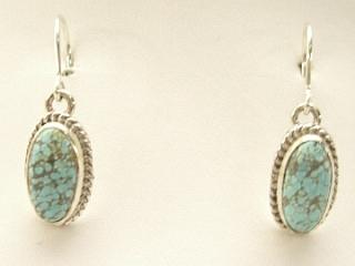 Genuine Number 8 Mine Turquoise Stones set in Sterling Silver French Wire Earrings. The Number 8 mine is located in Eureka County Nevada. Since 1976 there has been no Number 8 Turquoise mined. There is however, an existing stock pile that Mr. Dowell Ward, the last owner of the Number 8 mine, had stocked away for later sorting. The Turquoise is a collector's item--because once the reserve is gone there will be no more material released onto the market. The Gold Mining Company owns the claim to the Number 8 mine and it has been swallowed up by the gold mining operations. This is some of the last Number 8 Turquoise to be had and will be a great addition to your collection. Created by Navajo Artist Henry Begay. Signed.  
