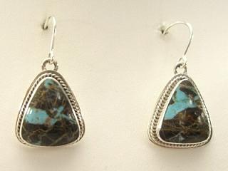 Genuine Sunnyside Turquoise set in Sterling Silver French Wire Earrings. The matrix on this rare stone is outstanding. The Sunnyside mine is located in northern Nevada near the town of Tuscarora in the Tuscarora mountain range. The mine is no longer in operation as it has become part of a gold mining operation and a privately owned ranch. The Sunnyside mine was mined mostly in the 70's. You won't find much of this great turquoise around anymore except for old stashes. Created by Navajo Artist Milton Lee. Signed.