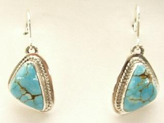 Genuine Number 8 Mine Turquoise Stones set in Sterling Silver French Wire Earrings. The Number 8 mine is located in Eureka County Nevada. Since 1976 there has been no Number 8 Turquoise mined. There is however, an existing stock pile that Mr. Dowell Ward, the last owner of the Number 8 mine, had stocked away for later sorting. The Turquoise is a collector's item--because once the reserve is gone there will be no more material released onto the market. The Gold Mining Company owns the claim to the Number 8 mine and it has been swallowed up by the gold mining operations. This is some of the last Number 8 Turquoise to be had and will be a great addition to your collection. Created by Navajo Artist Arkie Nelson. Signed.
