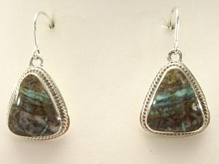 Genuine Sunnyside Turquoise set in Sterling Silver French Wire Earrings. The matrix on this rare stone is outstanding. The Sunnyside mine is located in northern Nevada near the town of Tuscarora in the Tuscarora mountain range. The mine is no longer in operation as it has become part of a gold mining operation and a privately owned ranch. The Sunnyside mine was mined mostly in the 70's. You won't find much of this great turquoise around anymore except for old stashes. Created by Navajo Artist Milton Lee. Signed. 
