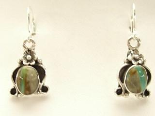Genuine Boulder Turquoise set in Sterling Silver French Wire Earrings. The cabachons are of Boulder Turquoise, you can see the veins of Turquoise running through the host rock. The Boulder Turquoise Mine is located in northeast Nevada. It was discovered in 1970 by a Shoshone sheep herder. Production is small due to the remote location and winter weather. Boulder Turquoise is valued for both it's beauty and rarity. Every stone is unique. Created by Navajo Artist Berna Francisco. Signed.
