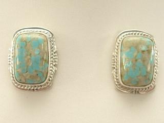 Genuine Number 8 Mine Turquoise Stones set in Sterling Silver Post Earrings. The Number 8 mine is located in Eureka County Nevada. Since 1976 there has been no Number 8 Turquoise mined. There is however, an existing stock pile that Mr. Dowell Ward, the last owner of the Number 8 mine, had stocked away for later sorting. The Turquoise is a collector's item--because once the reserve is gone there will be no more material released onto the market. The Gold Mining Company owns the claim to the Number 8 mine and it has been swallowed up by the gold mining operations. This is some of the last Number 8 Turquoise to be had and will be a great addition to your collection. Created by Navajo Artist Kathy Yazzie. Signed.