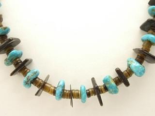 Authentic Native American Jewelry. Genuine Assorted Gemstones in this Horse Fetish Necklace. Featuring Genuine Turquoise and Onyx with Natural Penshell Heishi. Sterling Silver Cones and Clasp. Created by Navajo Artist Corrine Romeriz.