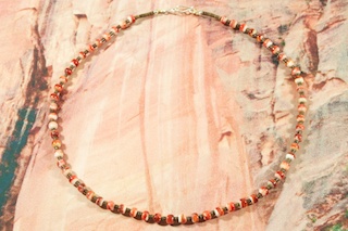 Stunning Santo Domingo Necklace. Created from Handcrafted Rolled Phosphersidecite from Chile, with Heishi Spacers. Sterling Silver Beads, Cones and Clasp. Beautiful One of a Kind work of Art. Created by Santo Domingo Artist Lester Abeyta. The Santo Domingo Pueblo is in New Mexico, near Santa Fe. 
