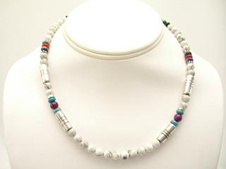 Assorted Genuine Gemstones Necklace with Sterling Silver Barrels. Featuring Genuine Howllite, Turquoise, Blue Lapis and Black Onyx. Sterling Silver Beads and Clasp. Created by Navajo Artist Tommy Singer.