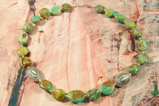 Genuine Sleeping Beauty Turquoise Nuggets with Sterling Silver Beads. Stunning Necklace with Sterling Silver Fluted Beads and Clasp. Created by Santo Domingo Artist Carol Pacheco. The Santo Domingo Pueblo is in New Mexico, near Santa Fe.