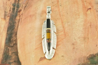 Genuine Royston Turquoise set in Sterling Silver Pendant. Beautiful Turquoise Stone. Created by Navajo Artist Emerson Delgarito. Signed. The Royston Turquoise Mine is located in Nye County, Nevada.  Free 18 inch Sterling Silver Chain with purchase of pendant.